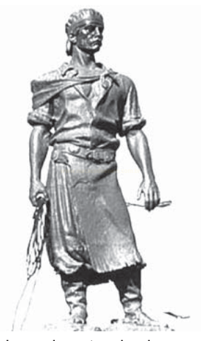 Escultura em preto e branco de um homem de avental e gorro, segurando objetos em cada mão.