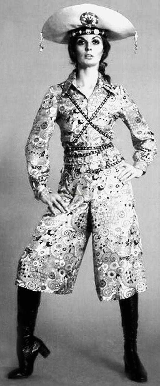 Fotografia de moda em preto e branco de uma mulher com chapéu de aba larga, conjunto estampado e botas de cano alto.